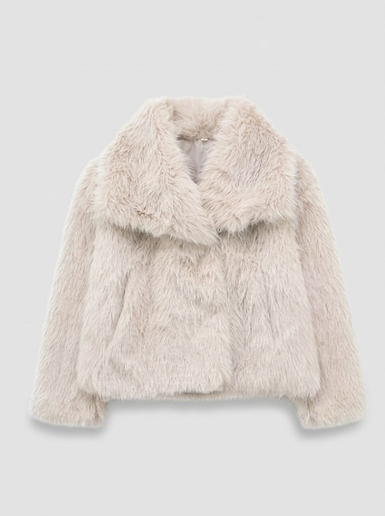 A light beige faux fur jacket with a wide collar, displayed against a neutral light gray background.